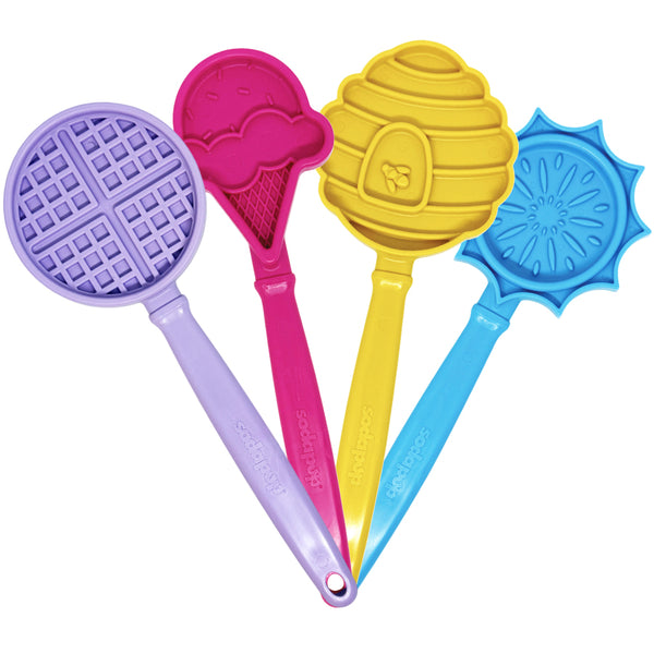 Four SodaPup eStick lick sticks in purple waffle, pink ice cream cone, yellow honeycomb, and blue sun designs