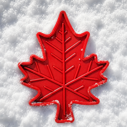 Red Maple Leaf chew toy in the snow