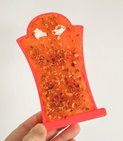 Headstone chew toy spread with an orange treat mix