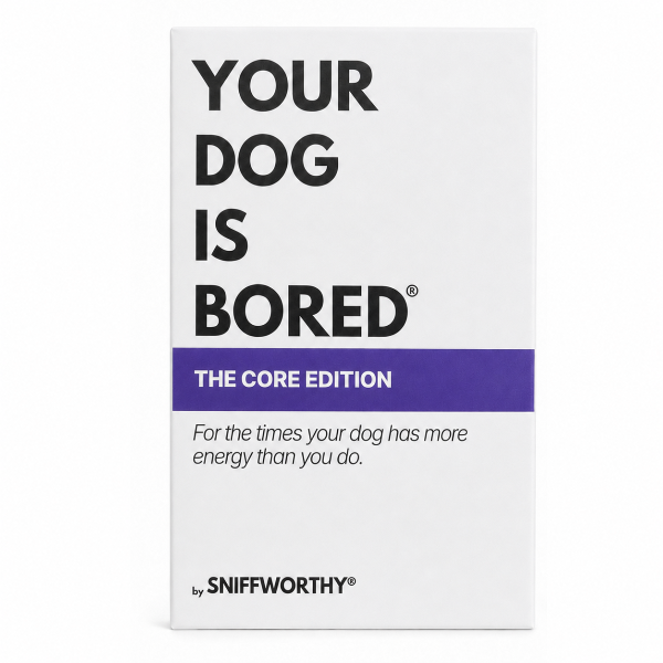 A white rectangular product box with bold black text reading 'YOUR DOG IS BORED' and a purple band that says 'THE CORE EDITION.' Smaller text reads 'For the times your dog has more energy than you do.