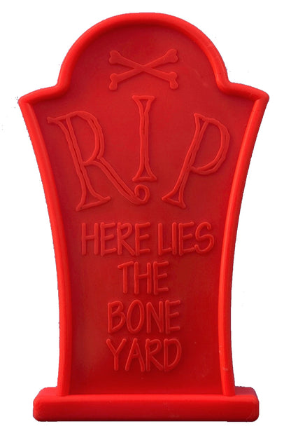 Red Headstone nylon chew toy that reads RIP Here Lies the Bone Yard