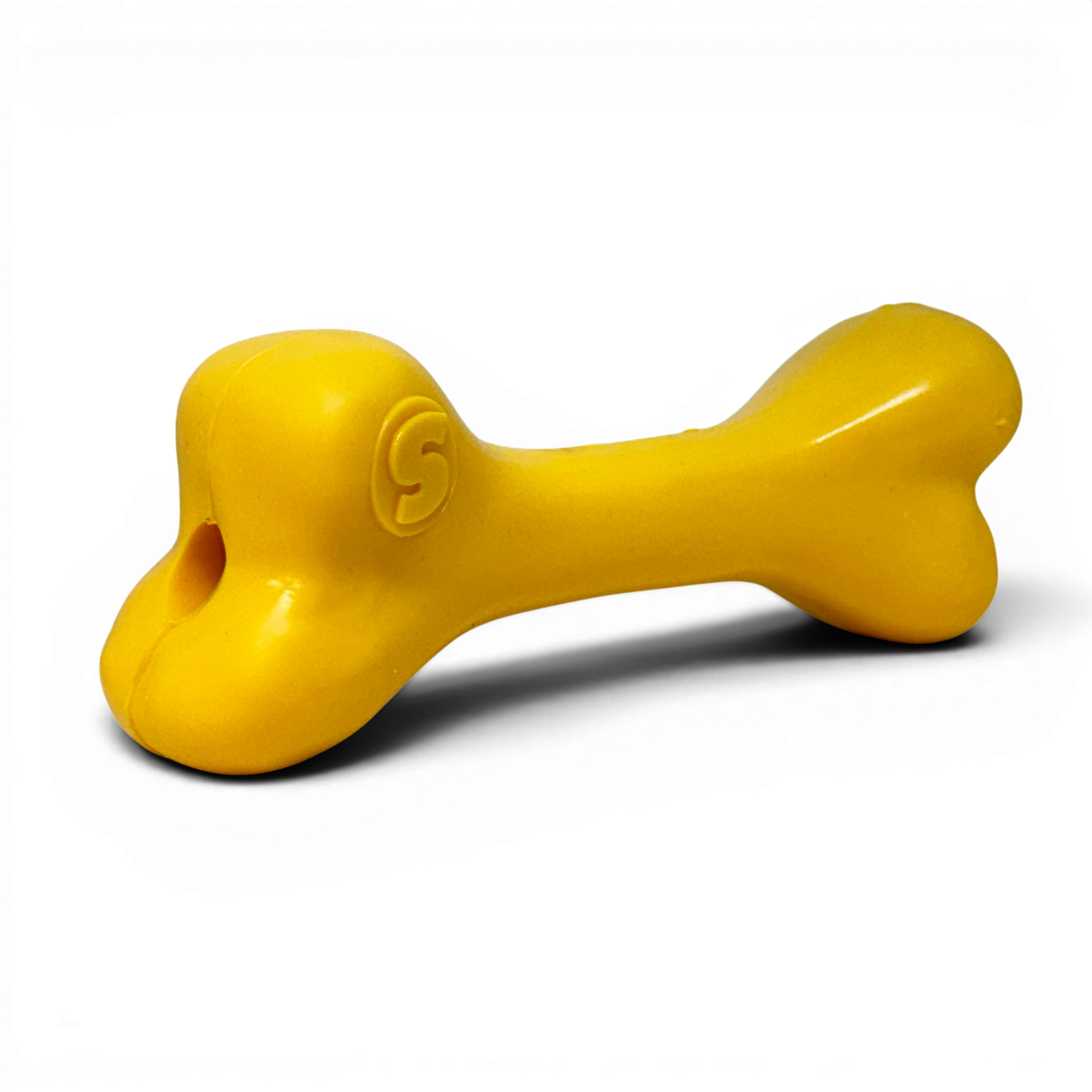 Yellow bone-shaped toy on a white background