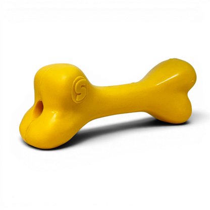 Yellow bone-shaped toy on a white background