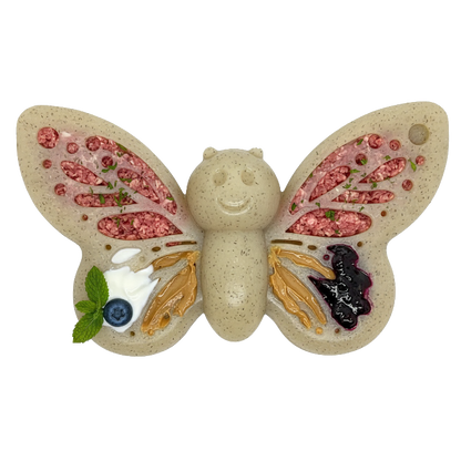 Butterfly-shaped dog chew toy with colorful filling on a white background