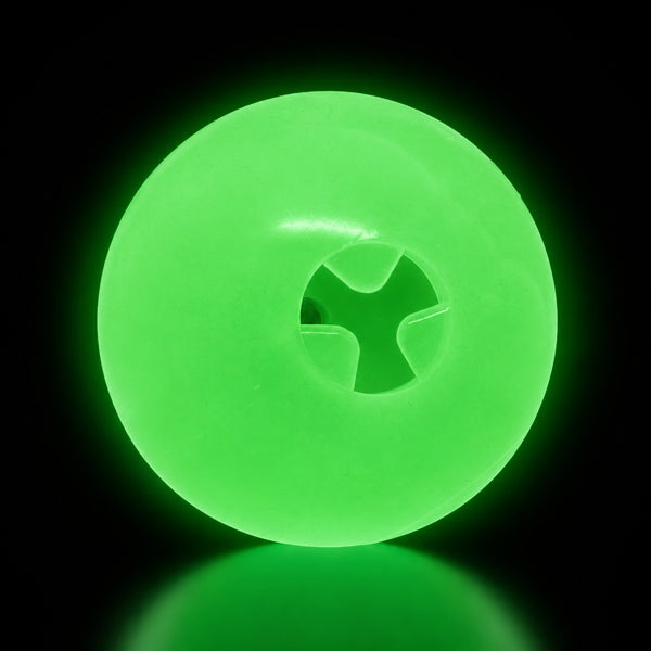 SodaPup 4-inch Glow Ball treat dispenser glowing green in the dark