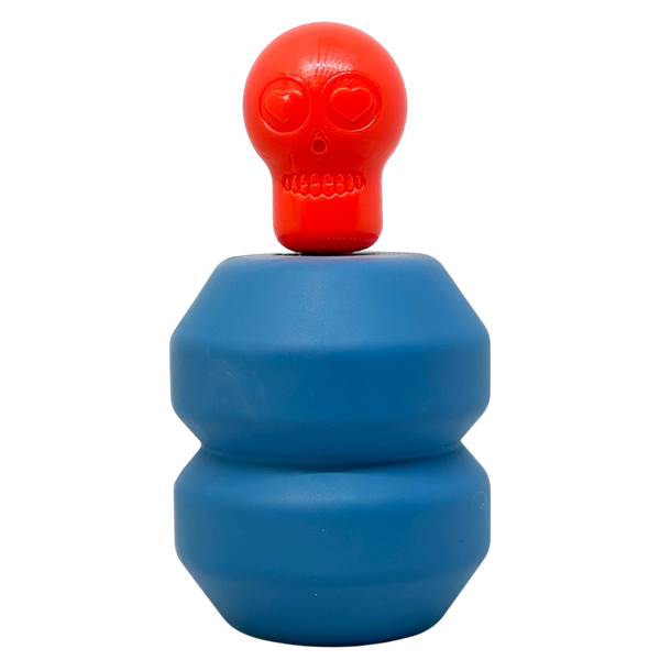 Red skull Unstoppables Chewer plugged into a blue treat dispenser